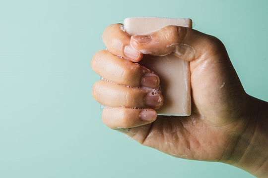 A hand holding a bar of soap.