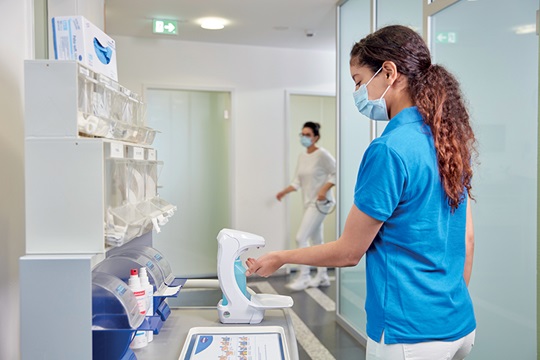 A nurse disinfects her hands in the hospital.