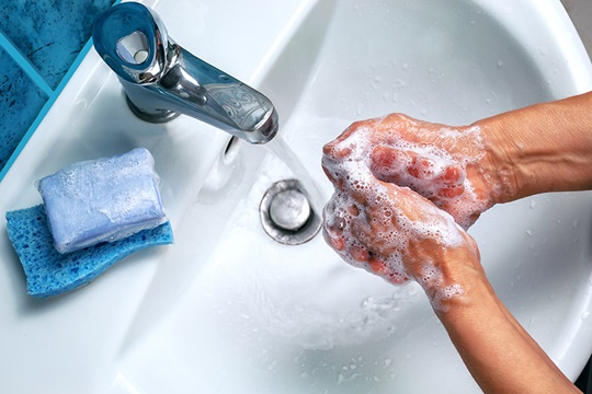 Close-up of hands being washed