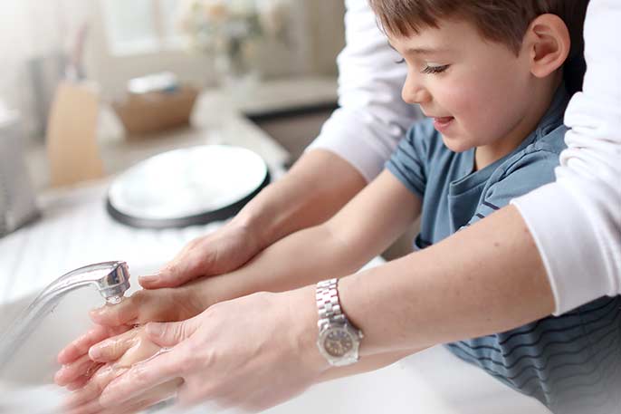 Boy washing his hands