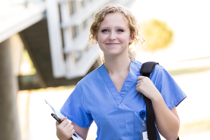 Nurse smiling and walking