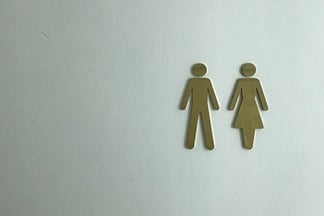 Man and woman symbol on the door of a public toilet.